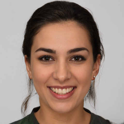 Joyful white young-adult female with medium  brown hair and brown eyes