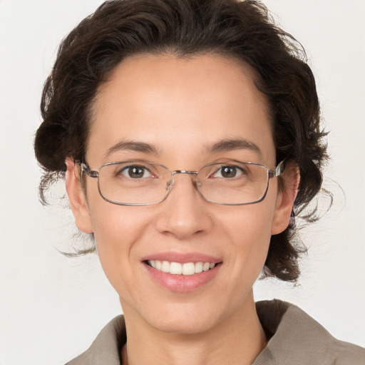 Joyful white adult female with medium  brown hair and grey eyes