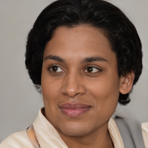 Joyful latino adult female with short  brown hair and brown eyes