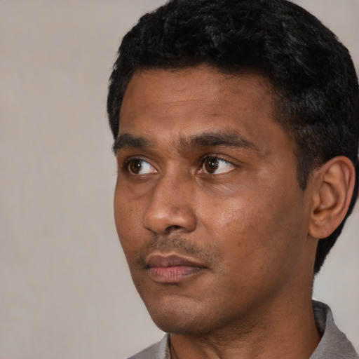 Neutral black young-adult male with short  black hair and brown eyes