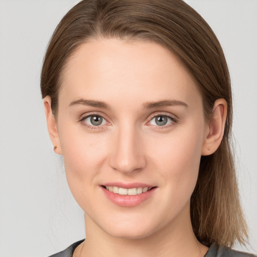 Joyful white young-adult female with long  brown hair and grey eyes