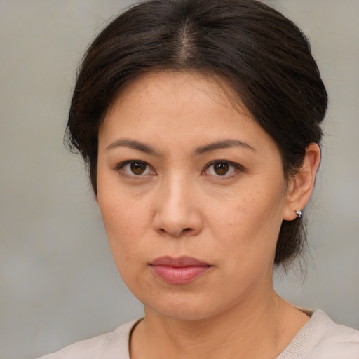 Neutral asian adult female with medium  brown hair and brown eyes