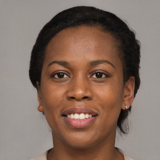 Joyful black young-adult female with medium  black hair and brown eyes