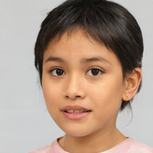 Joyful asian child female with medium  brown hair and brown eyes