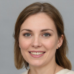 Joyful white young-adult female with medium  brown hair and grey eyes