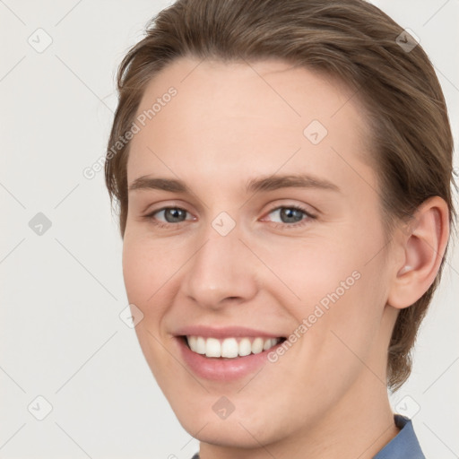 Joyful white young-adult female with medium  brown hair and grey eyes