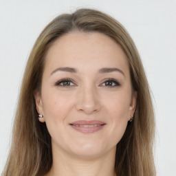 Joyful white young-adult female with long  brown hair and grey eyes