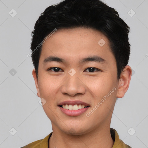 Joyful asian young-adult male with short  black hair and brown eyes