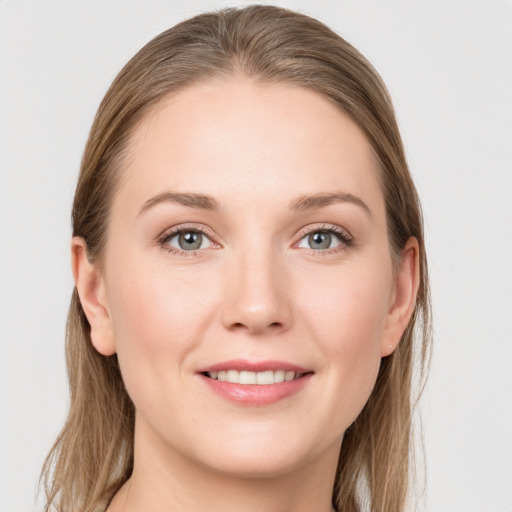 Joyful white young-adult female with long  brown hair and grey eyes