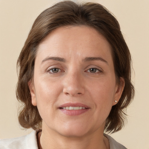 Joyful white adult female with medium  brown hair and brown eyes