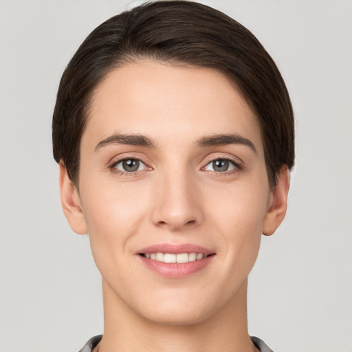 Joyful white young-adult female with short  brown hair and brown eyes