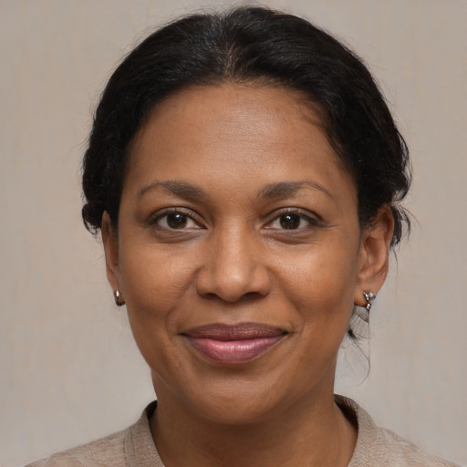 Joyful black adult female with short  brown hair and brown eyes