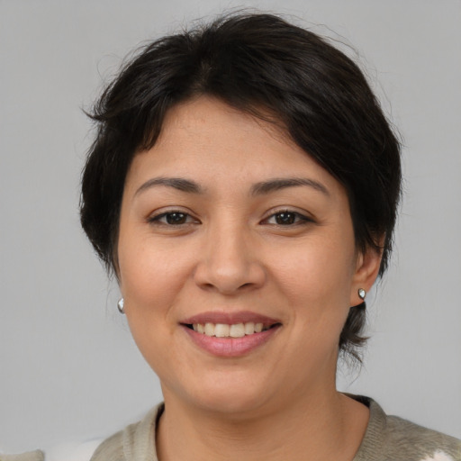 Joyful asian young-adult female with medium  brown hair and brown eyes