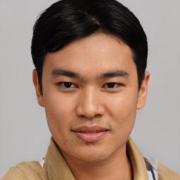 Joyful asian young-adult male with short  black hair and brown eyes