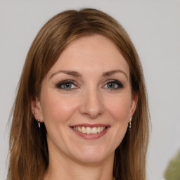 Joyful white young-adult female with long  brown hair and grey eyes