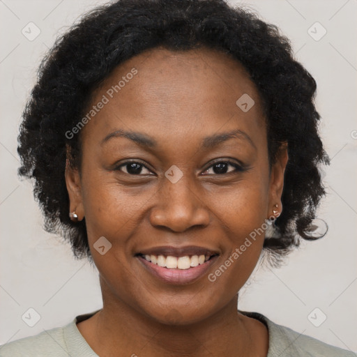 Joyful black adult female with short  brown hair and brown eyes