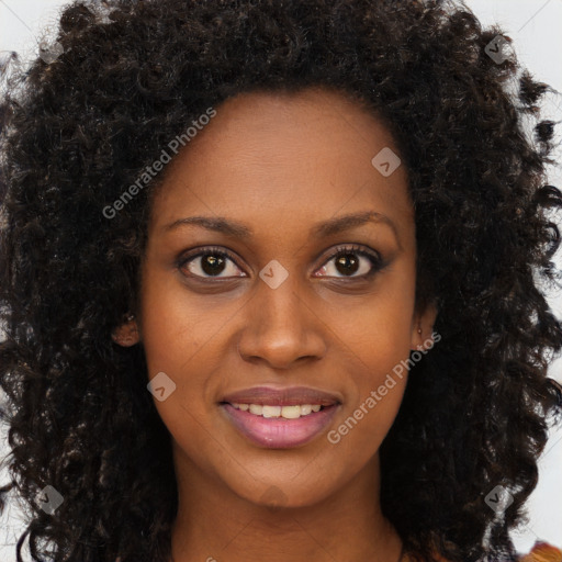 Joyful black young-adult female with long  brown hair and brown eyes