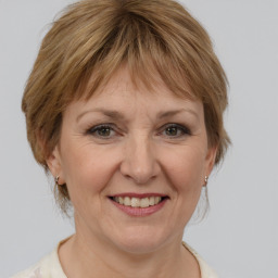 Joyful white adult female with medium  brown hair and brown eyes