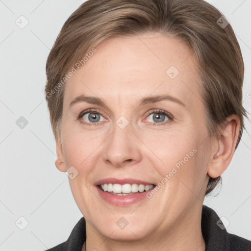 Joyful white adult female with short  brown hair and grey eyes