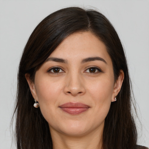 Joyful white young-adult female with long  brown hair and brown eyes