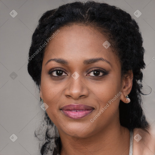 Joyful black young-adult female with long  black hair and brown eyes