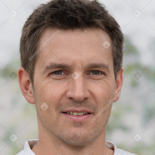 Joyful white adult male with short  brown hair and brown eyes