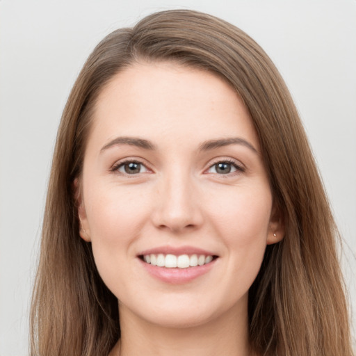 Joyful white young-adult female with long  brown hair and grey eyes