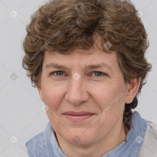 Joyful white adult female with medium  brown hair and blue eyes