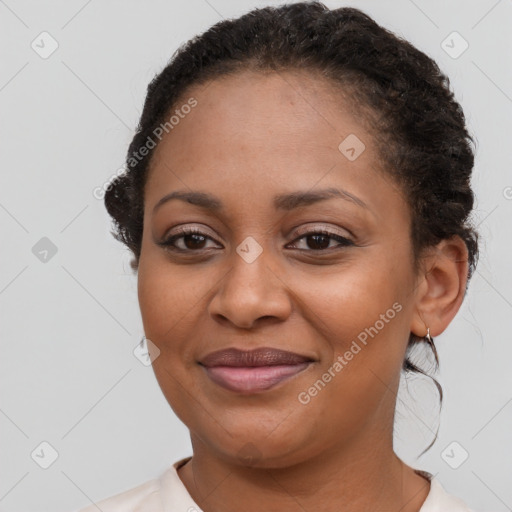 Joyful black young-adult female with short  brown hair and brown eyes