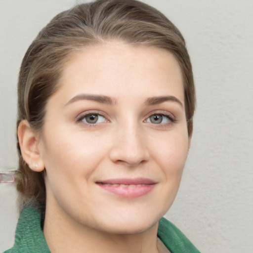 Joyful white young-adult female with medium  brown hair and green eyes