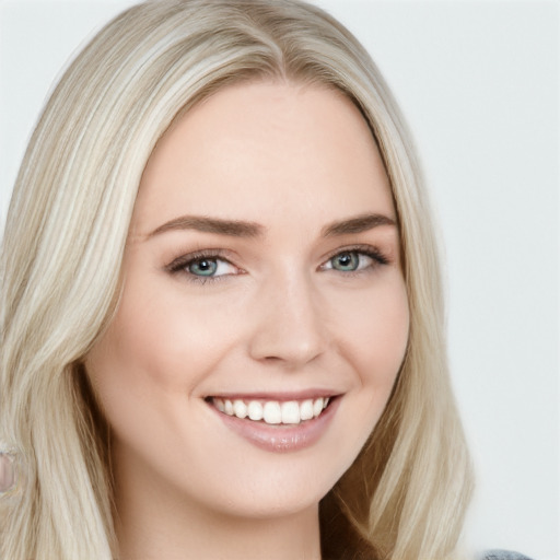 Joyful white young-adult female with long  brown hair and blue eyes