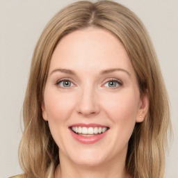 Joyful white young-adult female with long  brown hair and green eyes