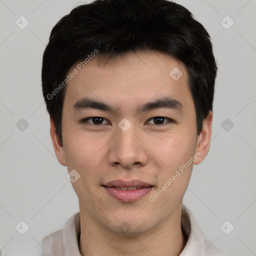 Joyful asian young-adult male with short  black hair and brown eyes