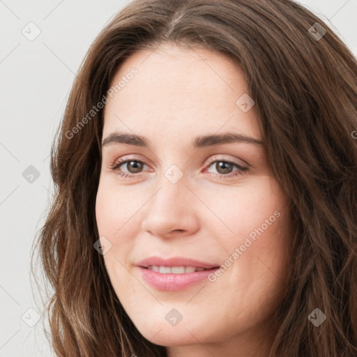 Joyful white young-adult female with long  brown hair and green eyes