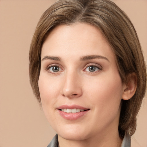 Joyful white young-adult female with medium  brown hair and grey eyes