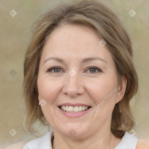 Joyful white adult female with medium  brown hair and brown eyes