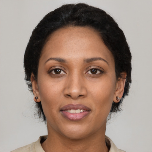 Joyful latino young-adult female with short  black hair and brown eyes