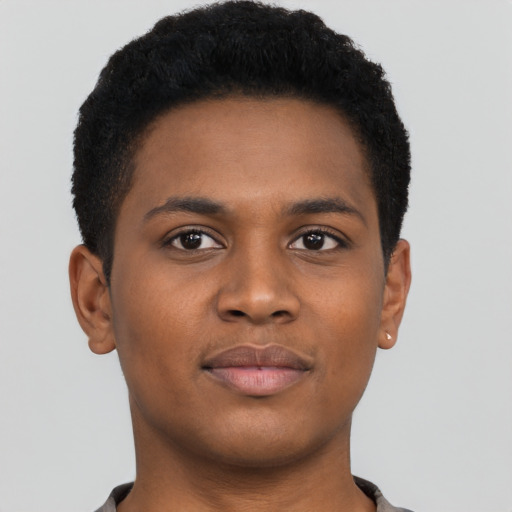 Joyful black young-adult male with short  brown hair and brown eyes