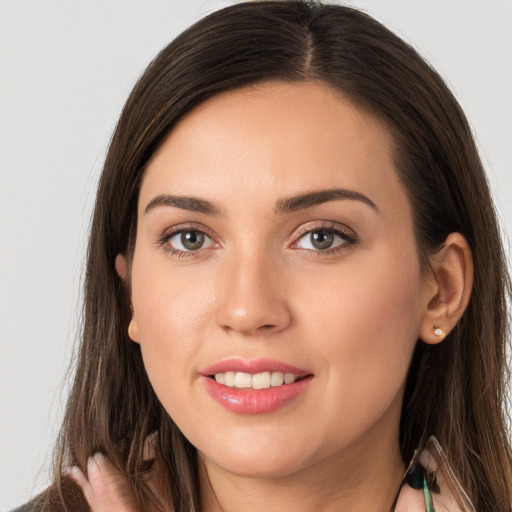 Joyful white young-adult female with long  brown hair and brown eyes