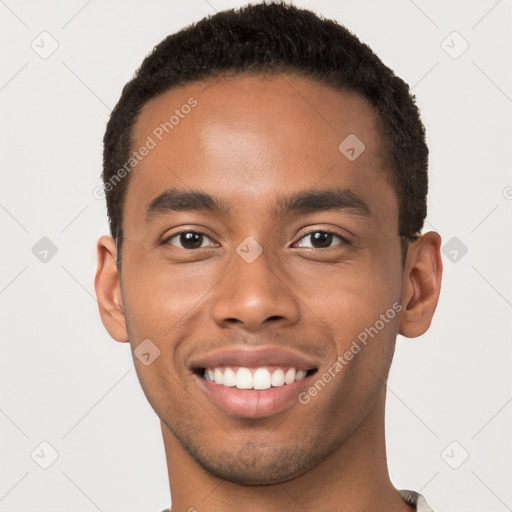 Joyful black young-adult male with short  brown hair and brown eyes