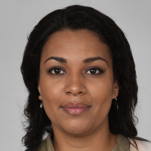 Joyful black adult female with medium  black hair and brown eyes