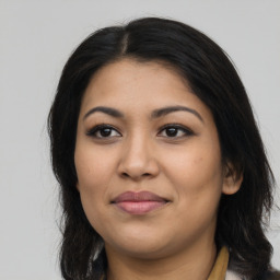 Joyful latino young-adult female with long  brown hair and brown eyes