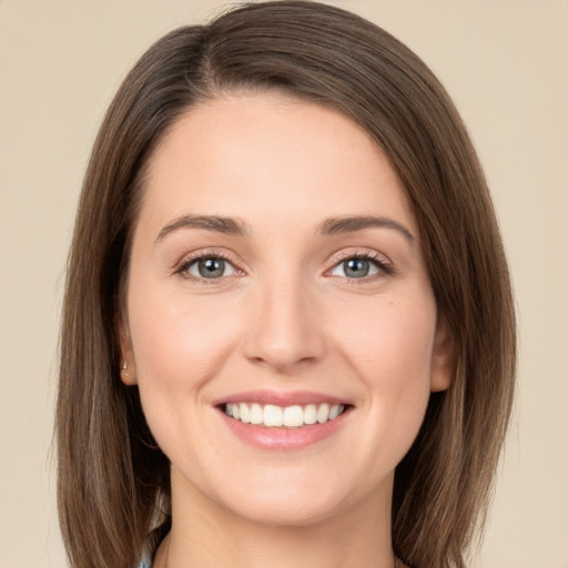 Joyful white young-adult female with long  brown hair and green eyes