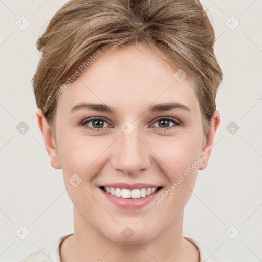 Joyful white young-adult female with short  brown hair and grey eyes