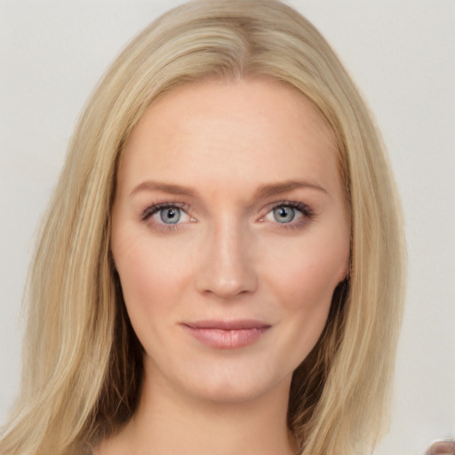 Joyful white young-adult female with long  brown hair and blue eyes