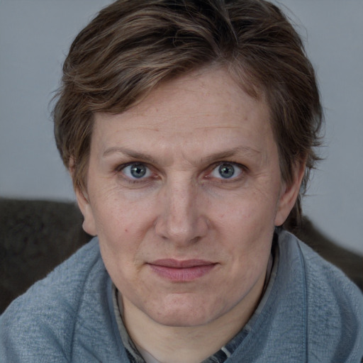 Joyful white adult female with medium  brown hair and blue eyes