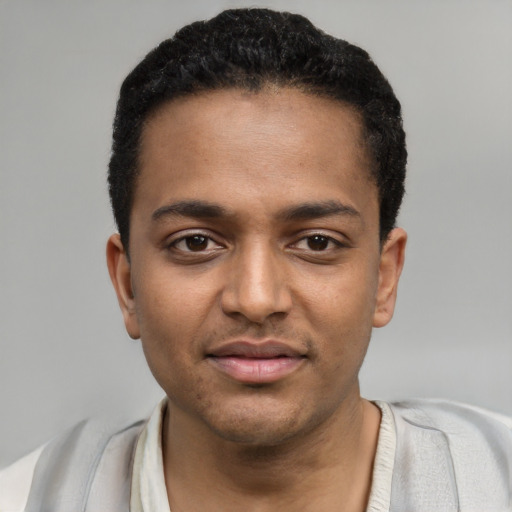 Joyful black young-adult male with short  black hair and brown eyes