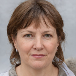 Joyful white adult female with medium  brown hair and grey eyes