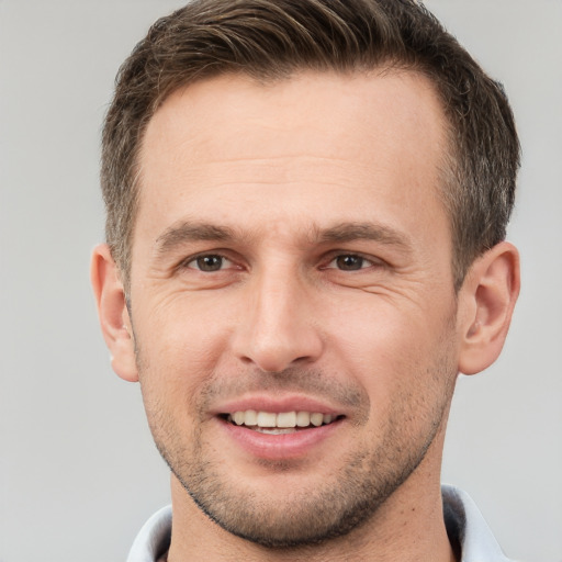 Joyful white young-adult male with short  brown hair and brown eyes