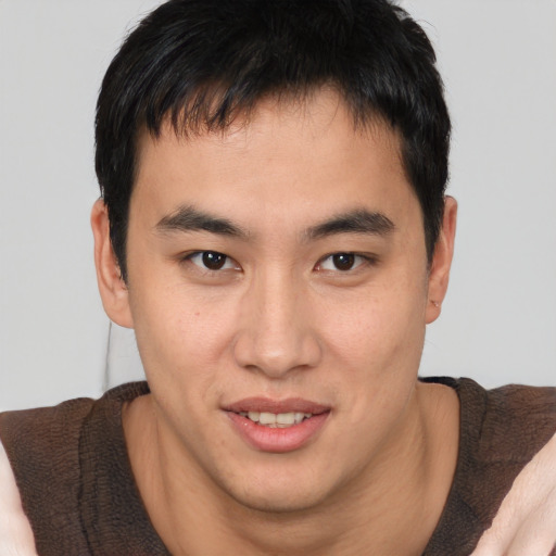 Joyful asian young-adult male with short  brown hair and brown eyes